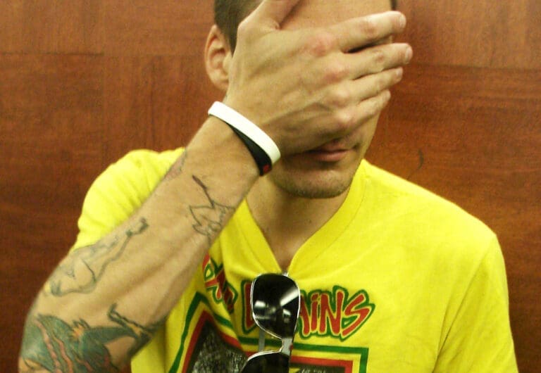 Aaron Solowoniuk covering his face