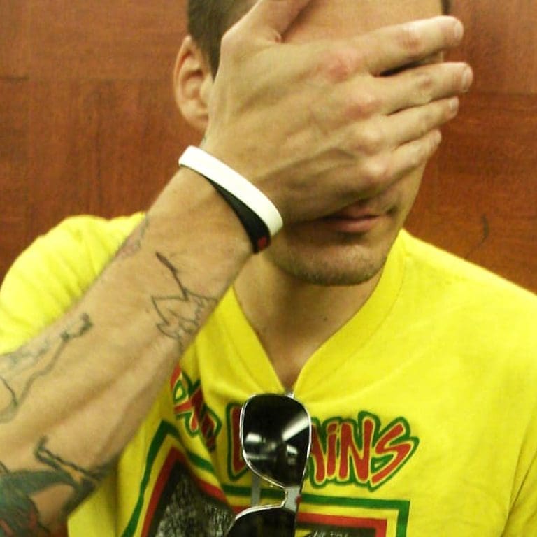 Aaron Solowoniuk covering his face